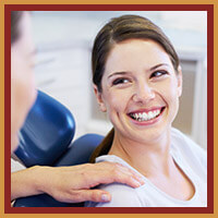 dentist speaking with smiling patient