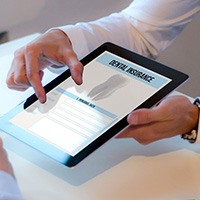 Patient reviewing dental insurance form on tablet
