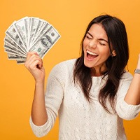 Woman holding a fan of money and celebrating her savings