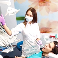 A woman scanning a patient’s mouth.