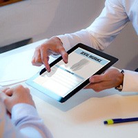 A patient discussing dental insurance with an insurance agent