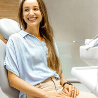 female patient smiling at dentist at dental appointment