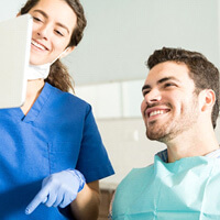 dentist showing patient image on tablet