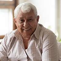 man smiling after paying cost of dentures in Carlisle