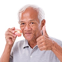 a man happy about the cost of dentures in Carlisle