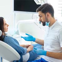 dentist talking to patient about tooth extractions in Carlisle