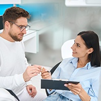 Female patient discussing dental insurance in Carlisle 
