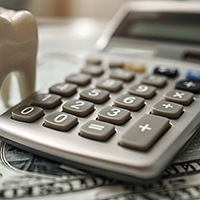 Calculator and pile of money