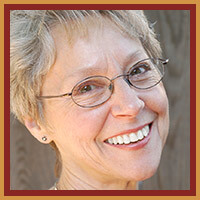 woman with glasses smiling