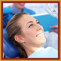 woman laying back smiling in exam chair