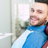 a patient smiling after visiting his dentist