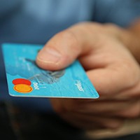 Man extending credit card for payment