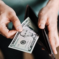 Man taking cash out of wallet