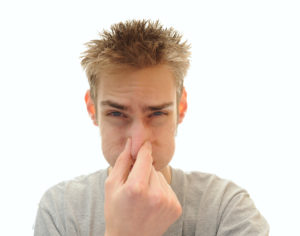 man holding nose