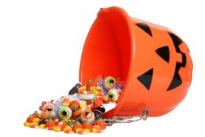 A bucket spilling Halloween candy.