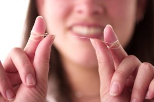 person holding dental floss