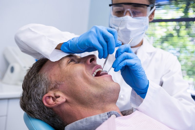 man reclining in dentist chair