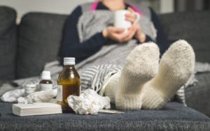 Sick person treating cold symptoms