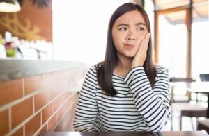 concerned woman suffering from cavities.