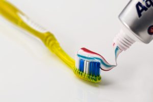 toothpaste going on toothbrush