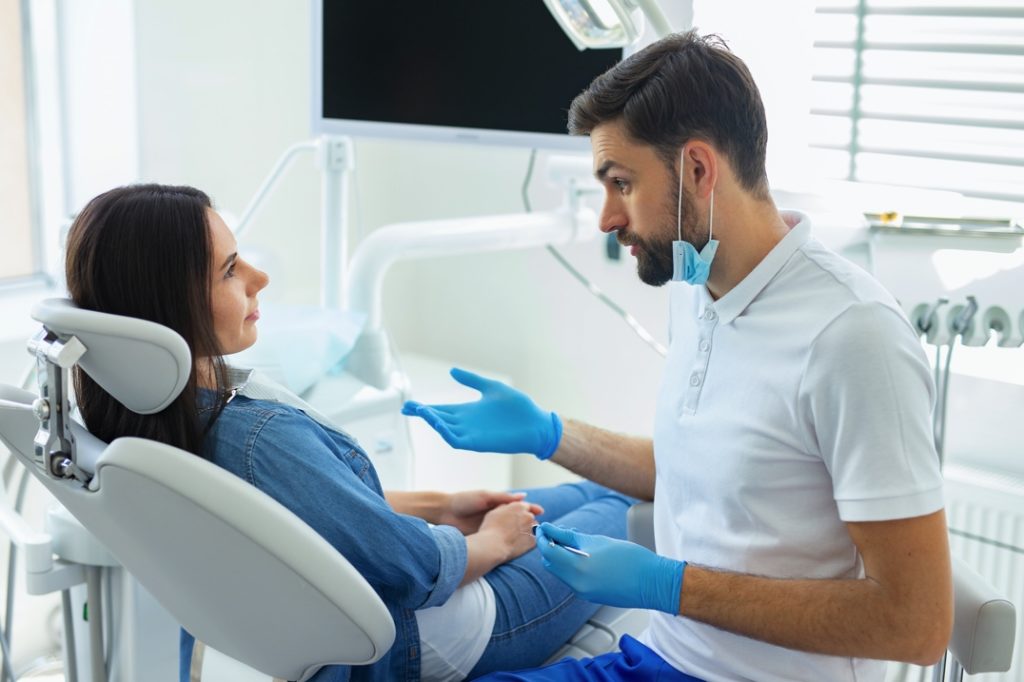 Woman asking her dentist questions