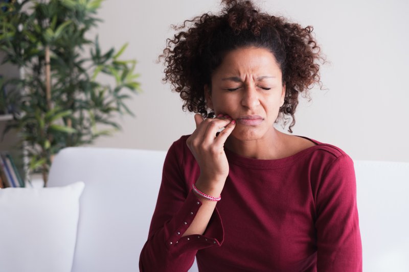 Woman with toothache needing to see dentist