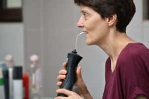 woman using Waterpik 