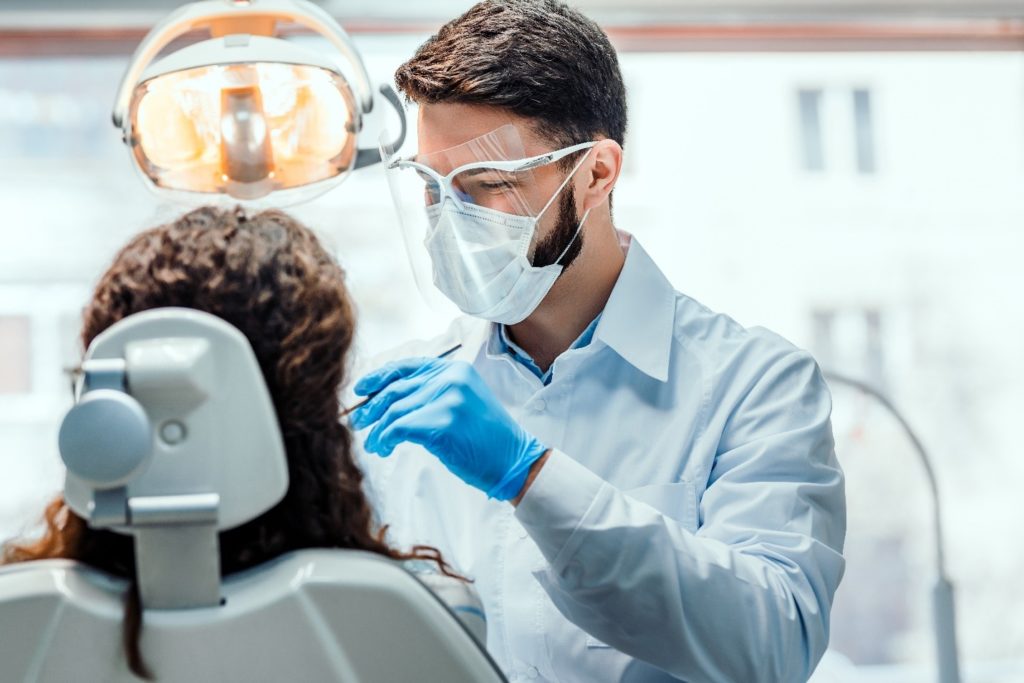 Patient at the dentist receiving a root canal.