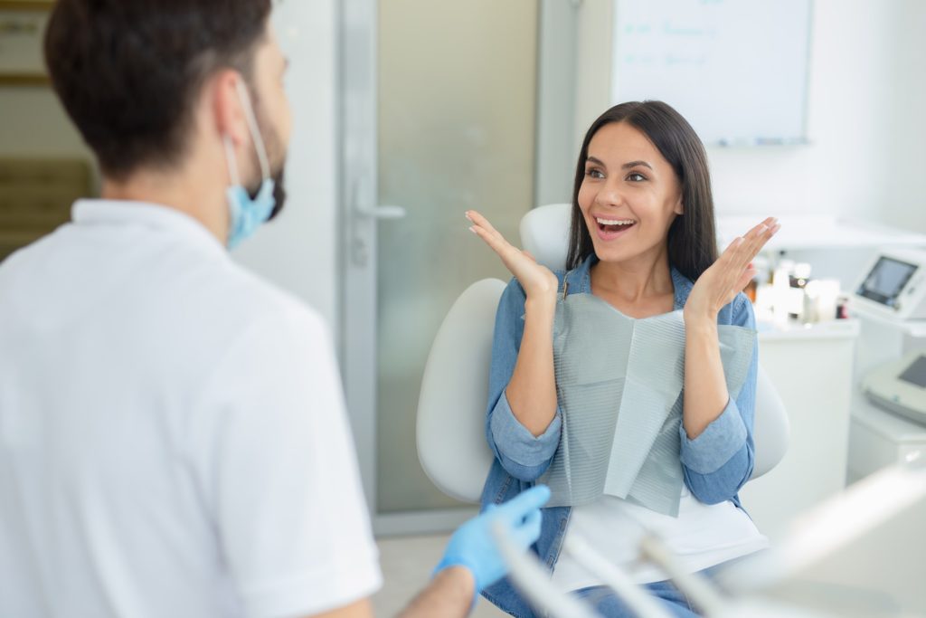 Woman smiling after learning facts about root canal therapy