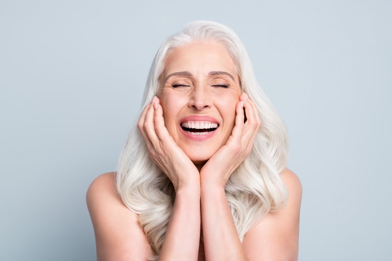 A close-up of a woman enjoying her dental implants