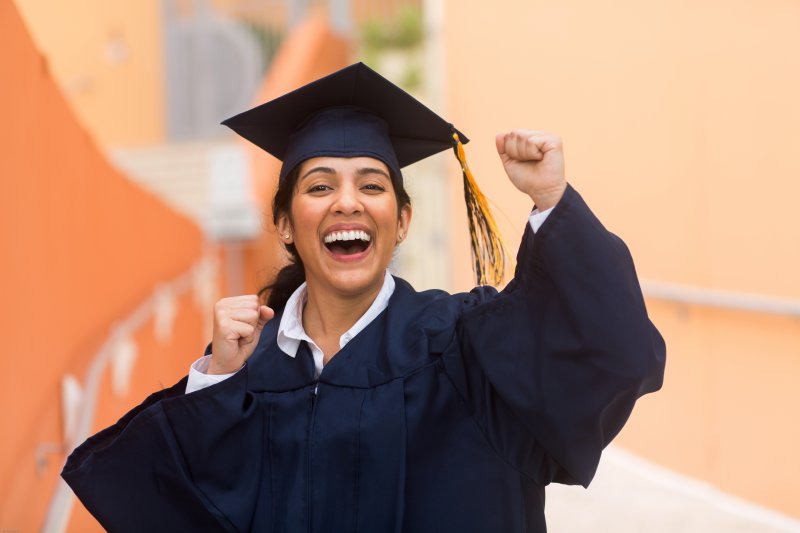 graduate smiling for the camera