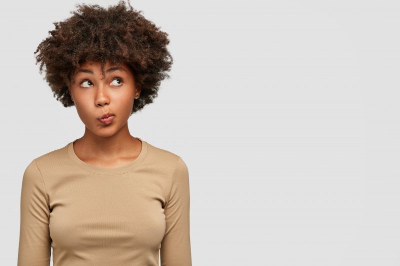 young woman with puzzled look on face