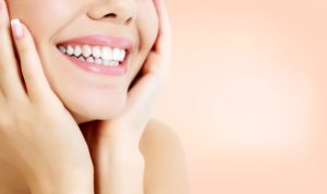 Woman with beautiful smile resting chin in hands