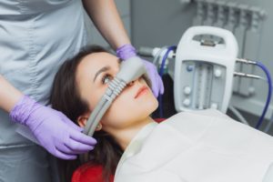 Dentist putting nitrous oxide mask on patient