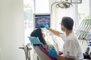 Dentist showing patient X-ray. 