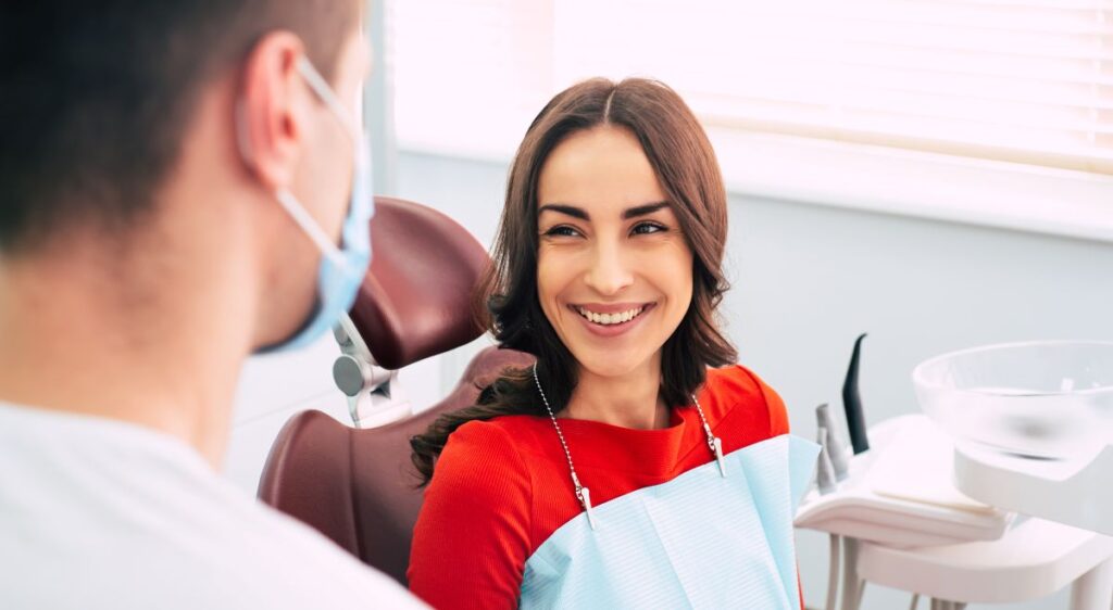 A smiling woman in a dental chair