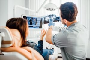 Dentist and patient looking at X-rays. 